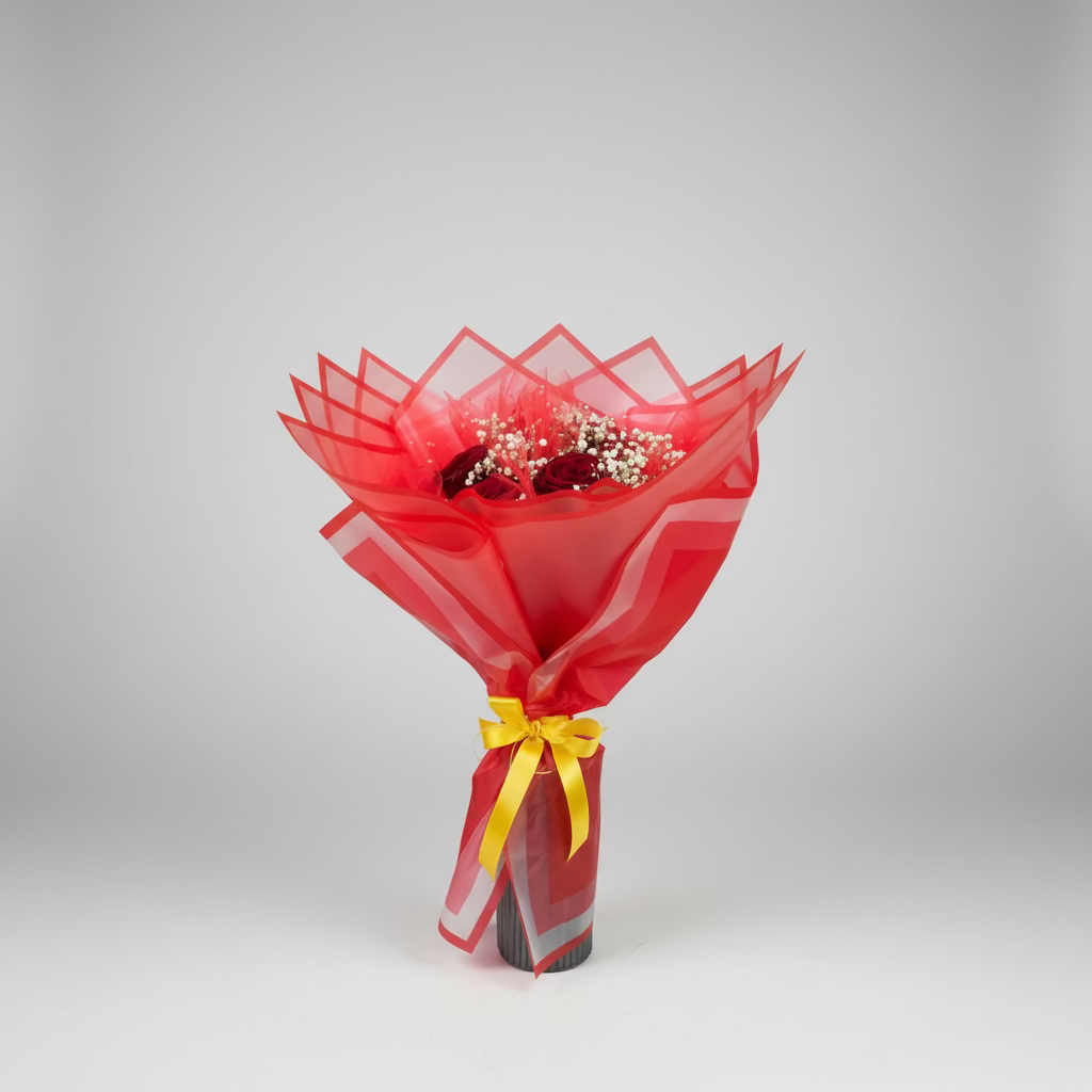 Bouquet of flowers wrapped in red paper with a yellow bow on a gray background